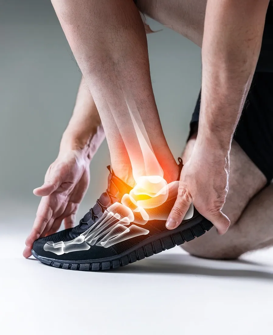 Close-up of an athlete holding an inflamed ankle with a 3D overlay showing joint bones and pain highlights.