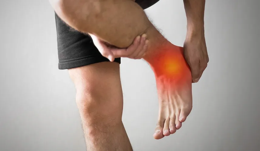 A person clutching a painful ankle injury with a red glow graphic overlay indicating severe swelling or an ankle sprain.
