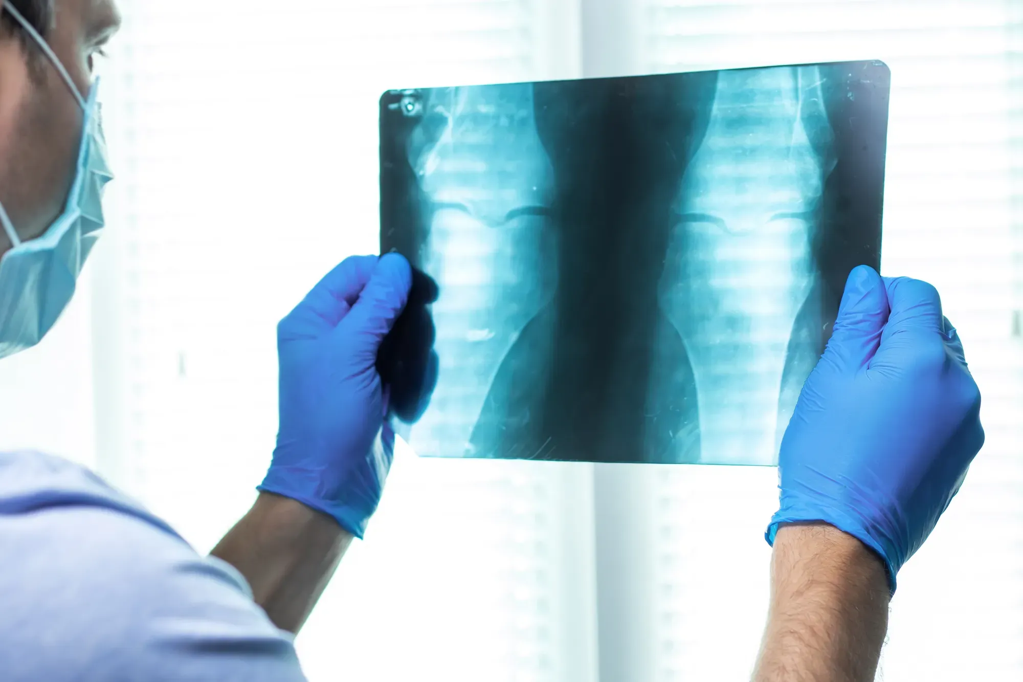 A medical professional referring to a model of the human foot in a consultation for Achilles pain management