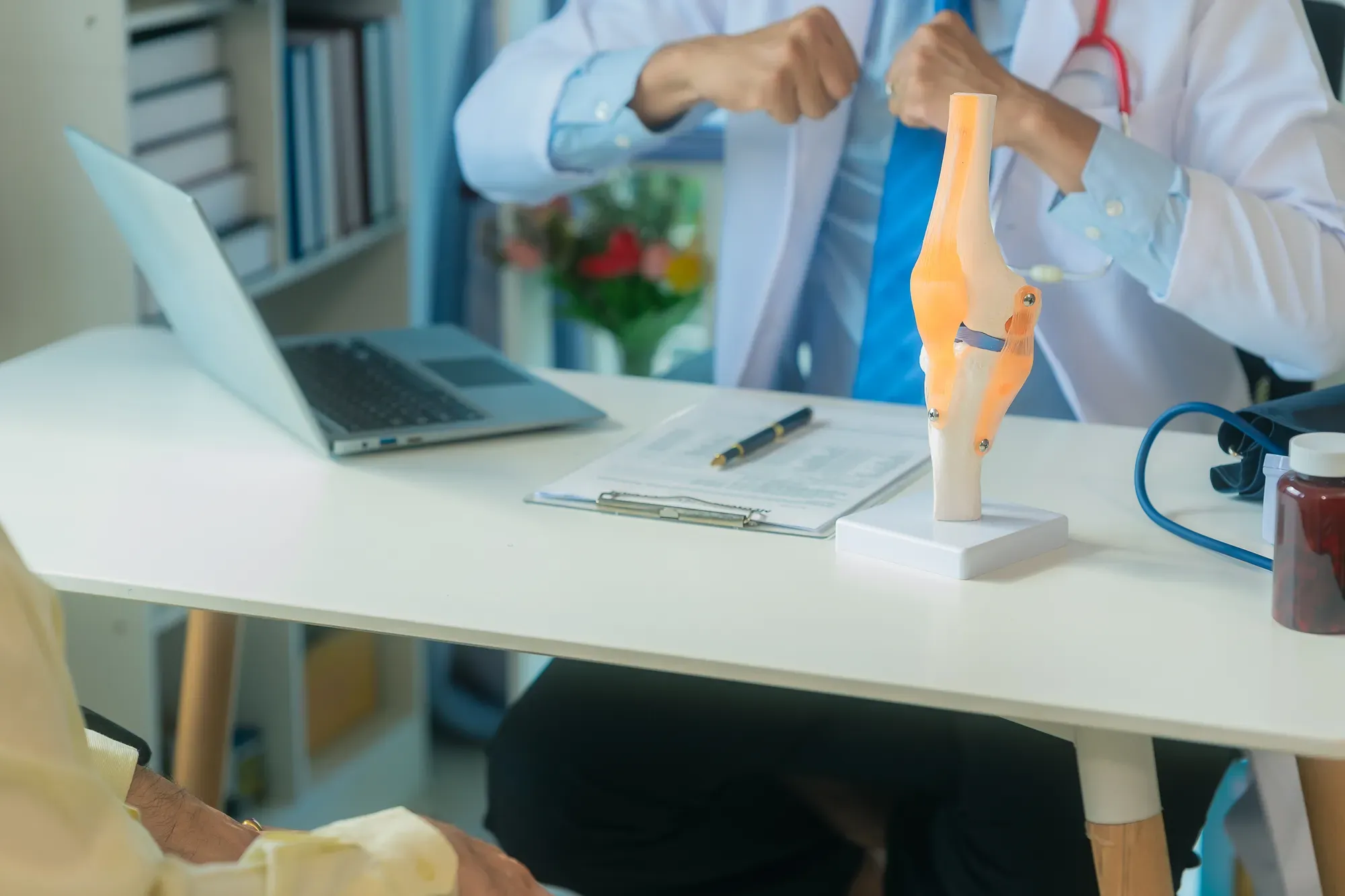 A specialist discussing stress fracture treatment options during a patient consultation.