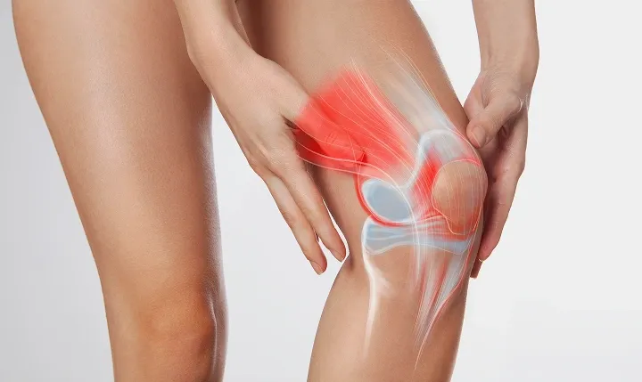 A person holding a painful knee joint, with a digital anatomical overlay showing bone structure and a red glow indicating joint inflammation.