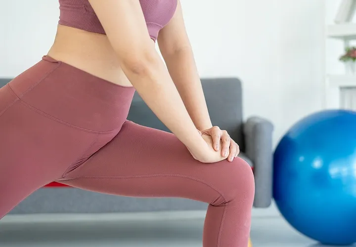 Person performing a knee rehabilitation stretch to improve strength and flexibility after a knee injury.